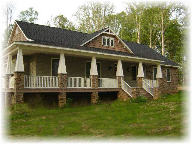 This is a color photo of the front of these craftsman homeplans.