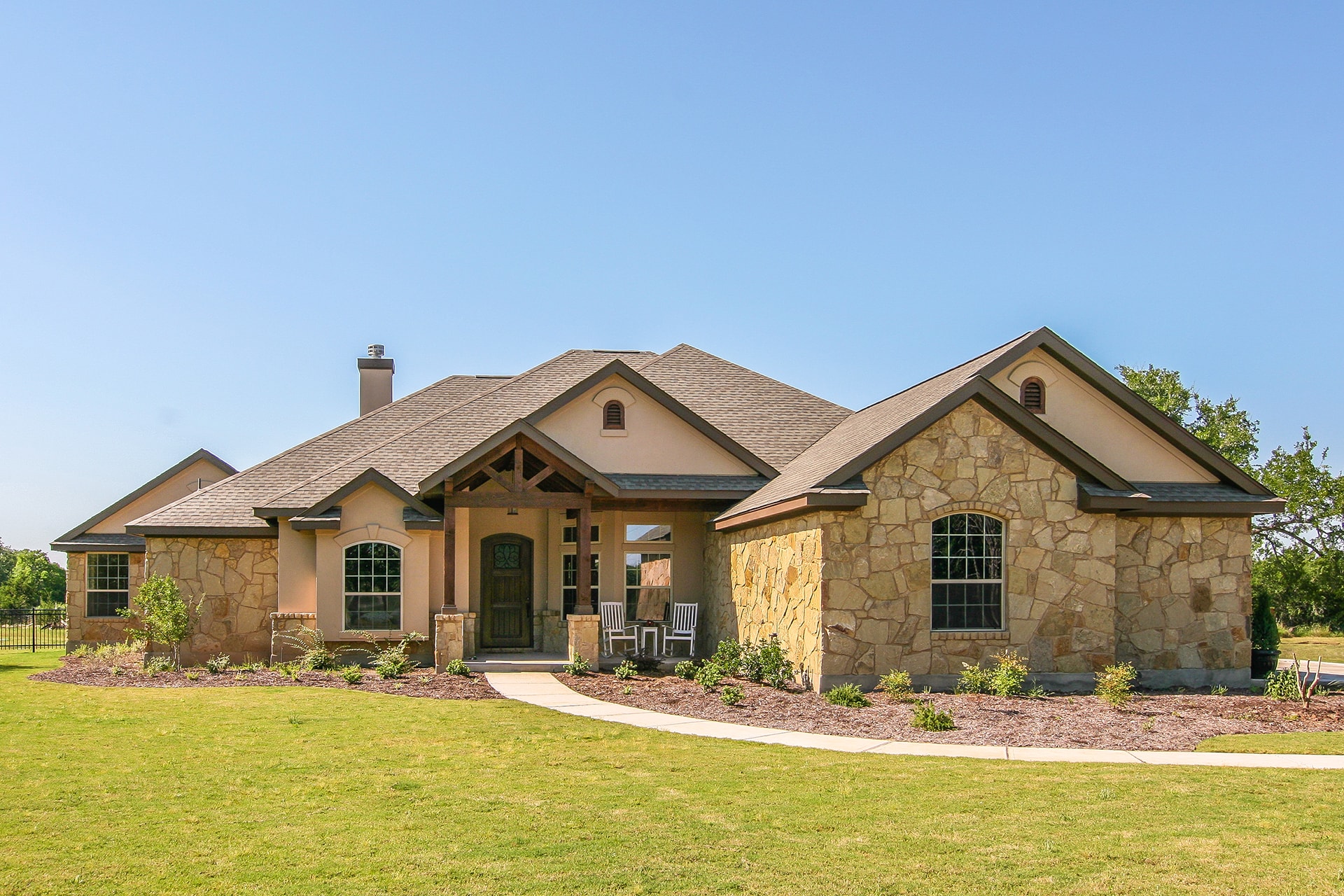 Color photograph of rustic ranch home (House Plan #136-1037)
