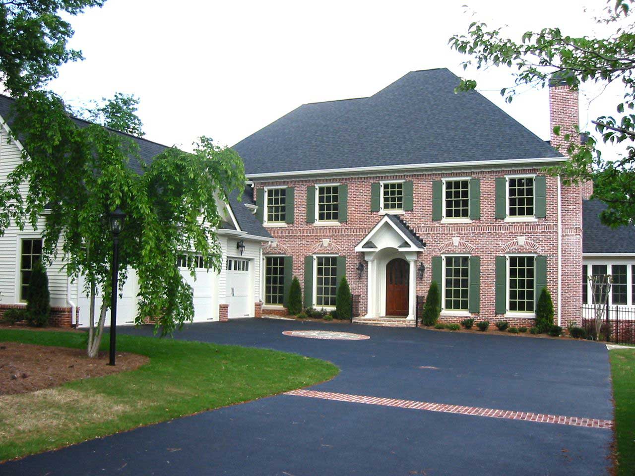 Front elevation of Colonial home (ThePlanCollection: House Plan #163-1028)