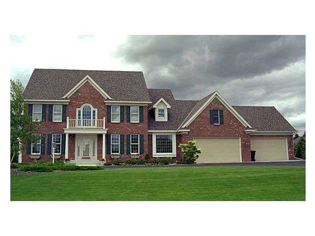 This photo shows the front elevation of these Colonial House Plans (CLS-3205).