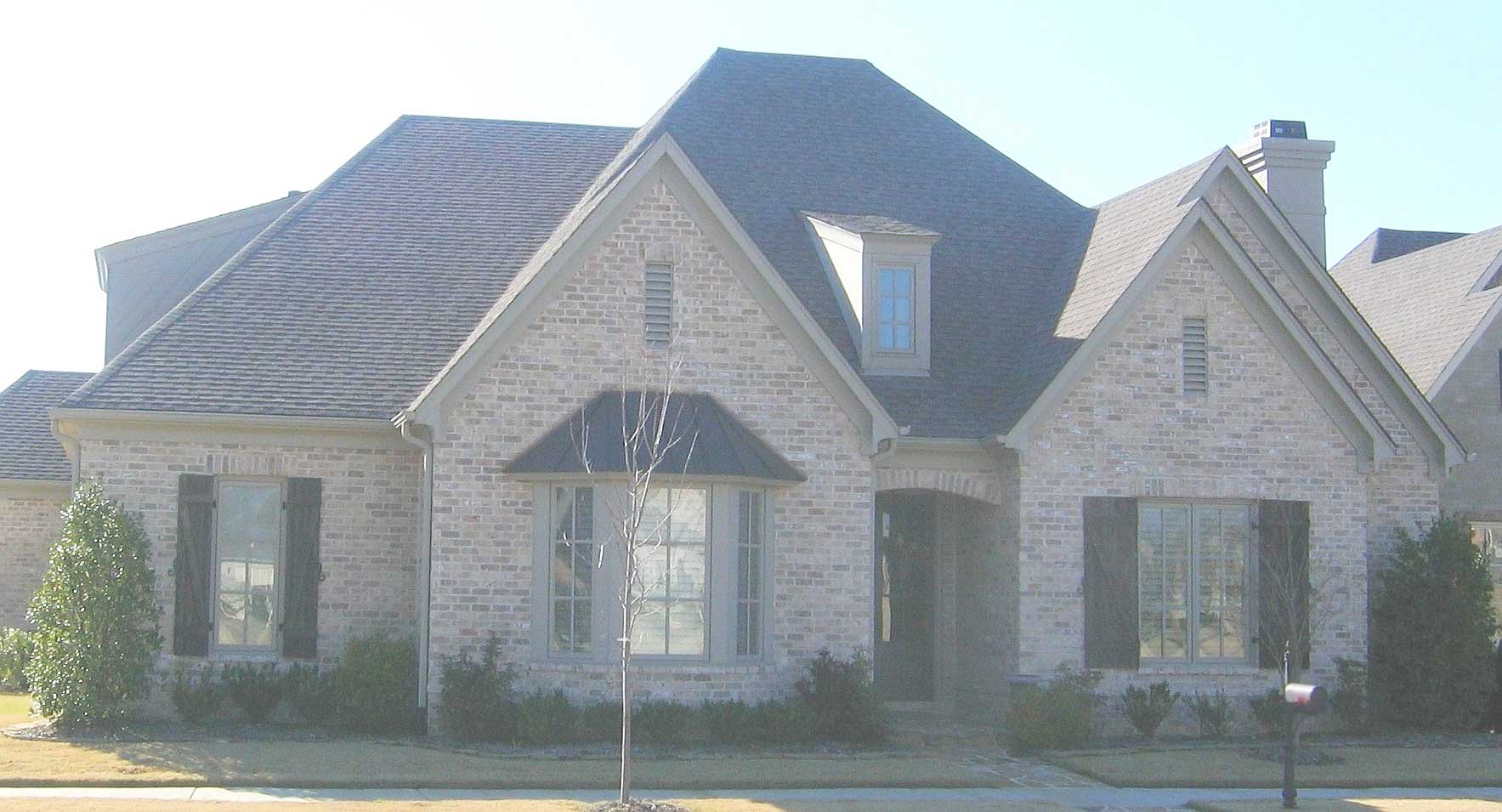 Front view of French home (ThePlanCollection: House Plan #170-1237)