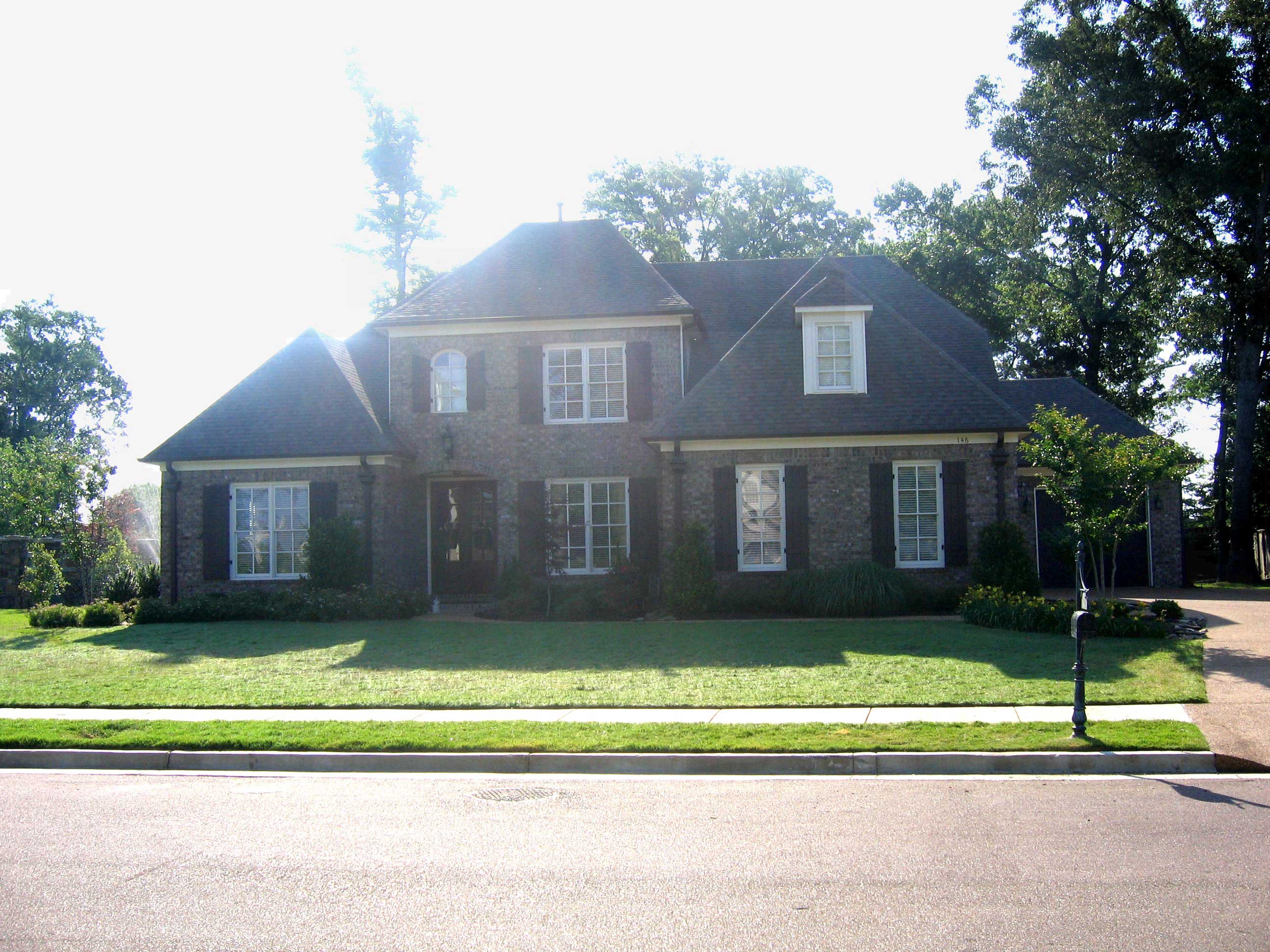 Front view of French home (ThePlanCollection: House Plan #170-3265)