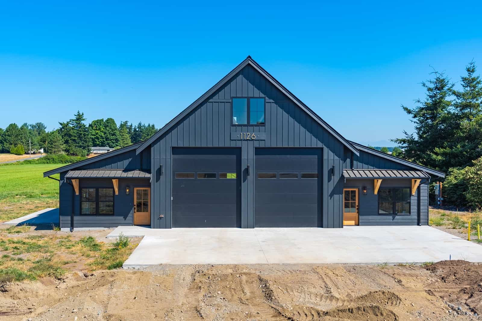 Front elevation of barndominium (ThePlanCollection: House Plan #214-1005)